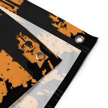 Load image into Gallery viewer, Person hanging a Halloween-themed wall art featuring a jack-o'-lantern on a white brick wall.